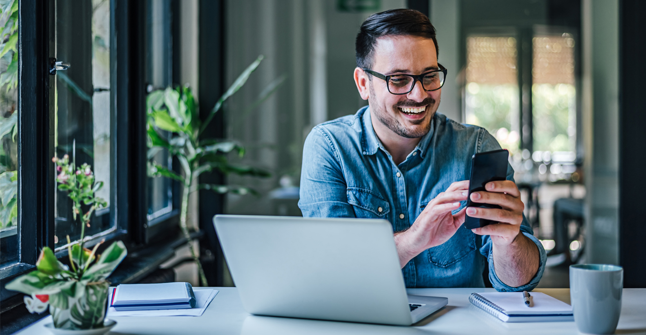 man on phone with laptop